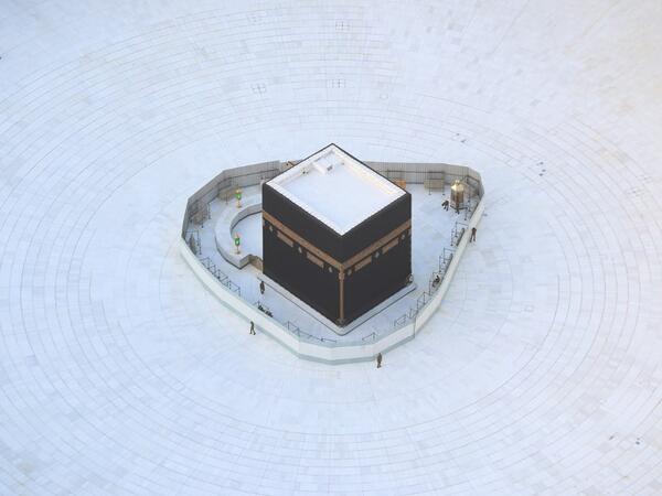 An aerial view shows an empty white-tiled area surrounding the Kaaba in Mecca's Grand Mosque, on March 6, 2020. An eerie emptiness enveloped the sacred Kaaba in Mecca's Grand Mosque, Islam's holiest site, where attendance at Friday prayers was hit by measures to protect against the deadly new coronavirus. Bandar ALDANDANI / AFP