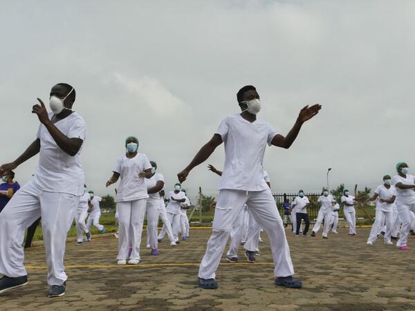 Nurses assigned to the Infectious Diseases Unit (IDU) at the Kenyatta University Hospital dance during a Zumba class held at the hospital compound in Nairobi, on May 17, 2020. Coinciding with the morning shift rotation the class, aimed to offer some respite to nurses charged with the management of patients infected with COVID-19 coronavirus, was organised by the Nursing Council of Kenya (NCK) and the Kenyatta Univesity Teaching, Refferal and Research Hospital in the Kenyan capital. TONY KARUMBA / AFP