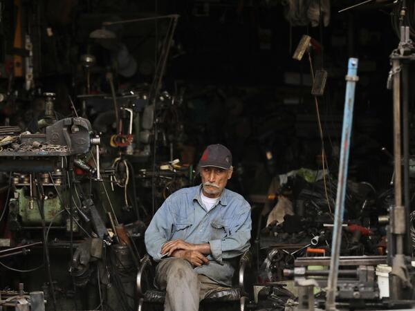 A man sits in a workshop in the Bab al-Tabbaneh neighbourhood of Lebanon's northern city of Tripoli on June 3, 2020. Thousands of residents of Lebanon's northern Tripoli struggle to put food on the table, as the country's worst economic crisis in decades has picked up in speed in recent weeks, with food prices rising by more than 70 percent since the autumn. Inflation has been a blow in the country where more than 45 percent of the country's population now lives below the poverty line, and more than 35 perc