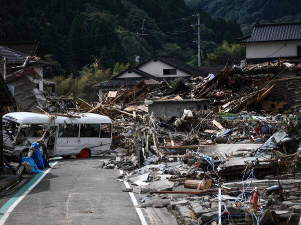 Debris litter a village following heavy rains and flooding in the village of Kuma, Kumamoto prefecture on July 8, 2020. Japan will deploy more troops to search for survivors of devastating floods and landslides that have killed at least 52 people in the southwest of the country, Prime Minister Shinzo Abe pledged CHARLY TRIBALLEAU / AFP