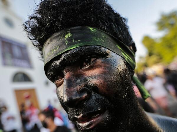 A Catholic faithful smeared in burnt oil takes part in the opening of the ten-day celebration of the Santo Domingo de Guzman festival, outside the Las Sierritas de Santo Domingo church in Managua, on August 1, 2020 amid the COVID-19 novel coronavirus pandemic. Despite the Catholic Church cancelling all religious activities due to the coronavirus pandemic, devotees gathered outside the church for the celebration. Inti OCON / AFP