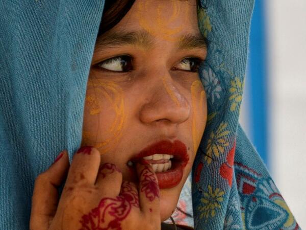 This photo taken on October 22, 2020 shows Rohingya refugee Amerah, 18, who said she has not seen her fiance -- who is a construction worker in Malaysia -- since she was six, at a temporary shelter in Lhokseumawe in Aceh province. Stay in a squalid refugee camp -- hopeless, starving, and made to feel a burden -- or leave, risking death, rape, human trafficking and months at sea to reach a husband you've never met. This is the bleak choice many Rohingya women, already scarred from fleeing persecution in Myan