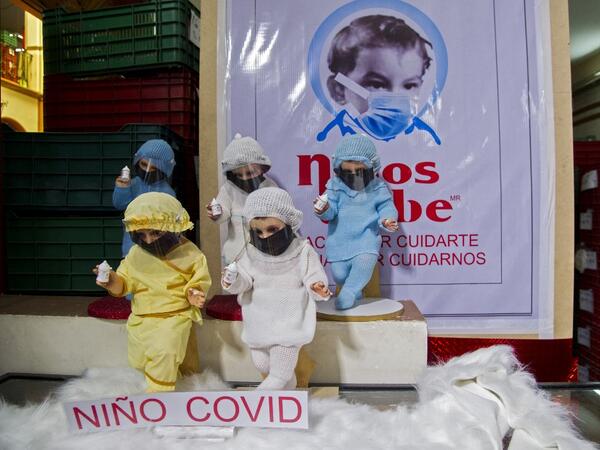 View of dolls displayed for sale at the ¨Nino Uribe¨ traditional Mexican store in Mexico City on January 27, 2021. ¨Nino Uribe¨ sells representations of the Baby Jesus called Baby COVID to raise awareness on the preventive measures to take amid the COVID-19 coronavirus pandemic. CLAUDIO CRUZ / AFP