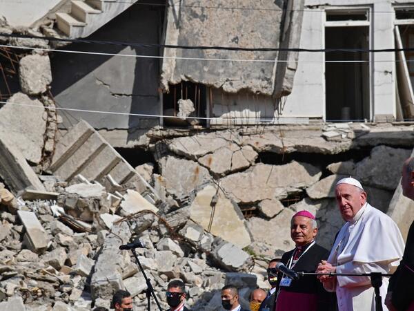 Pope Francis (R), accompanied by the Chaldean Catholic Archbishop of Mosul Najib Michaeel Moussa 