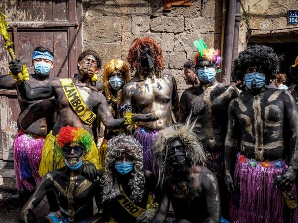 Carnival participants dressed in costume and wearing body paint pose for a group picture in the annual Lebanese Zambo carnival 