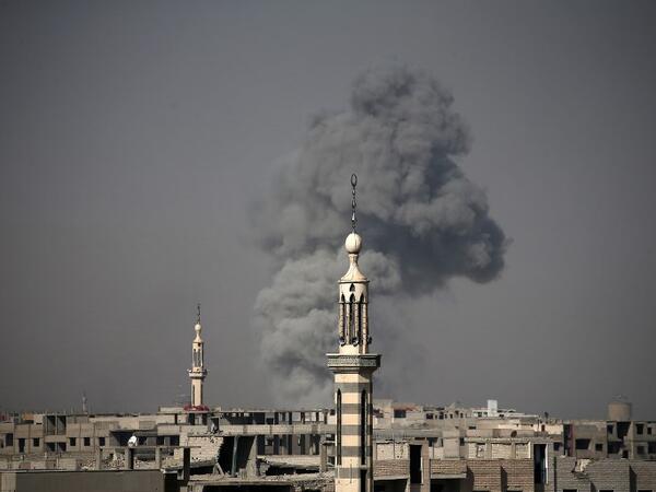 Smoke billows following Syrian government bombardment on the rebel-controlled town of Arbin, in the besieged Eastern Ghouta region on the outskirts of the capital Damascus on Mar. 12, 2018. 
(ABDULMONAM EASSA / AFP)