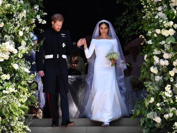 Britain's Prince Harry, Duke of Sussex and his wife Meghan, Duchess of Sussex walk down the west steps of St George's Chapel, Windsor Castle, in Windsor, on May 19, 2018 after their wedding ceremony. 
Ben STANSALL/ AFP