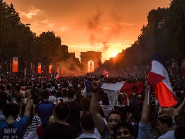 People celebrate France's victory in the Russia 2018 World Cup final football match between France and Croatia, on the Champs-Elysees avenue in Paris on July 15, 2018. 
Eric FEFERBERG / AFP 