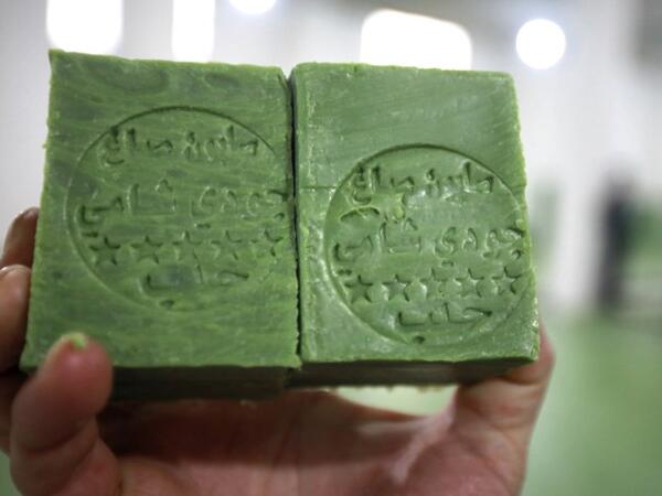 A Syrian worker displays soap bars in a factory on the outskirts of Aleppo 
LOUAI BESHARA / AFP