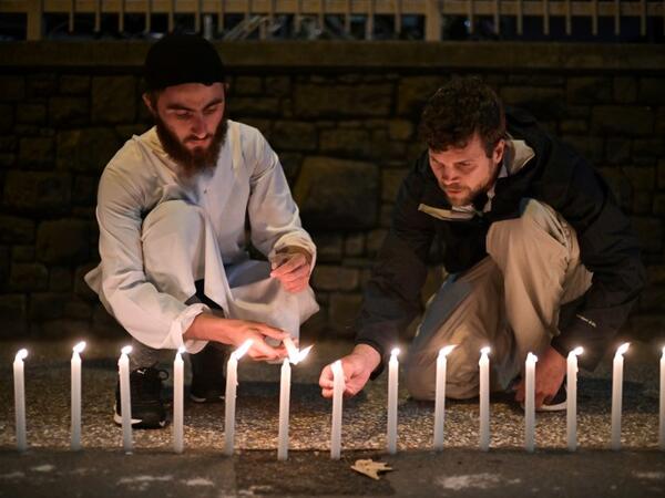 Well-wishers light 49 candles as they pay respects to victims outside the hospital in Christchurch 
Anthony WALLACE / AFP