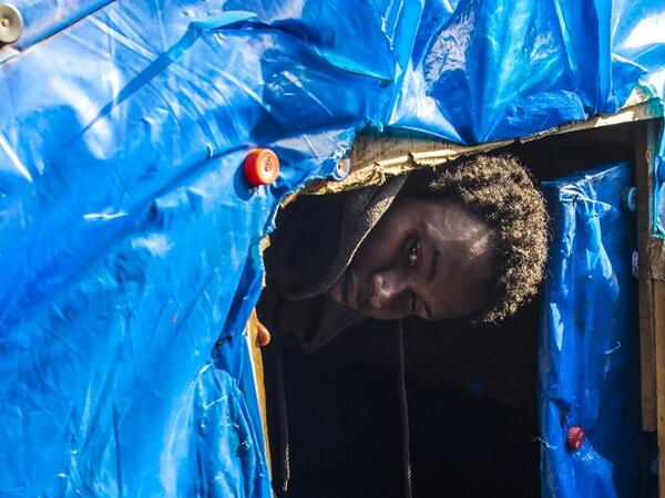 A sub-Saharan migrant comes out of a make-shift tent at the Oulad Ziane migrant camp in Casablanca on March 27, 2019. 
FADEL SENNA / AFP