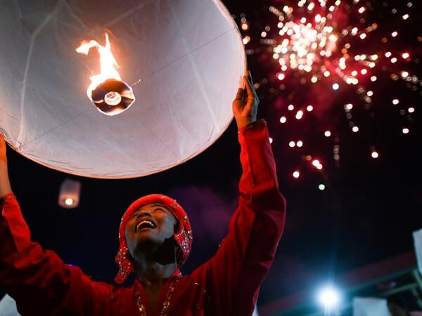 A man releases lantern as fireworks explode over a makeshift palace during abbot Kay Lar Tha's funeral in Mudon, Mon State. 
Ye Aung THU / AFP