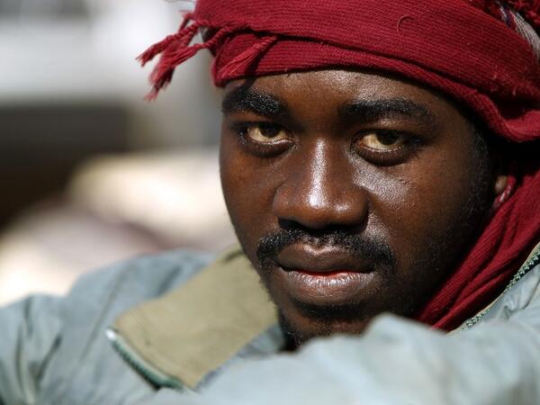 A sub-Saharan migrant sits at the Qanfouda detention center, in the southern outskirts of Benghazi, before being repatriated on Dec. 2, 2017. 
(Abdullah DOMA / AFP)