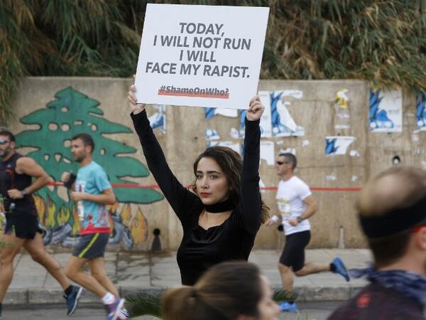 A protester holds a banner with a message against sexual assault during the 16th edition of the Beirut Marathon in the Lebanese capital on November 11, 2018. 