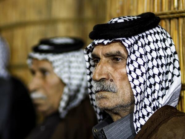 Members of an Iraqi clan gather inside a straw tent in the town of Mishkhab, south of Najaf on November 15, 2018. 
Haidar HAMDANI / AFP