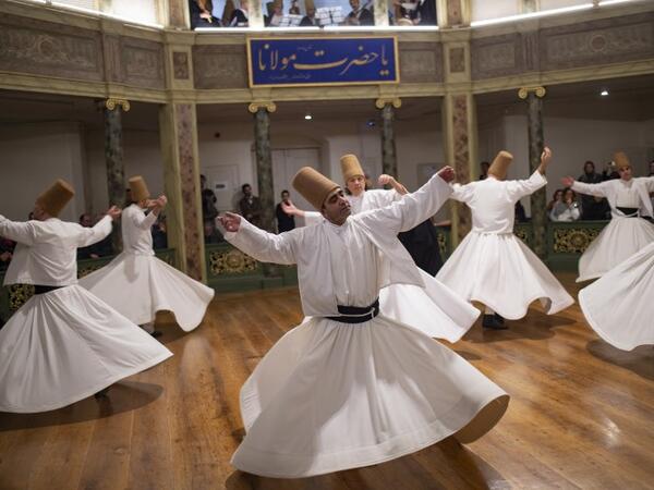 Whirling dervishes perform during a ceremony marking the anniversary of the death of Jelaleddin Mevlana Rumi, Sufi mystic, poet and founder of sufism on December 16, 2018 at Galata Mevlihanesi in Istanbul. Yasin AKGUL / AFP