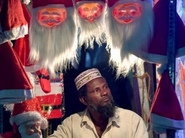 An Indian shopper arranges Santa Claus masks on display on a road side stall in Bangalore on December 19, 2018, ahead of the celebration of Christmas. 
MANJUNATH KIRAN / AFP