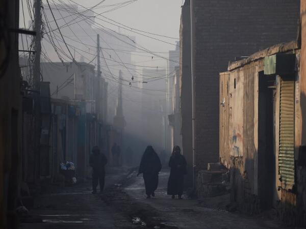 In this photograph Afghan residents walk along a street amid heavy smog conditions in the old quarters of Kabul. 
WAKIL KOHSAR / AFP
