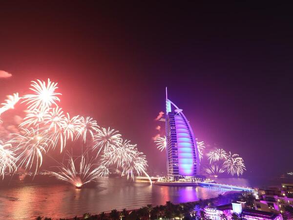 People watch fireworks exploding in front of the Atlantis Hotel at The Palm Jumeirah, in Dubai, United Arab Emirates, on January 1, 2019 (Twitter)
