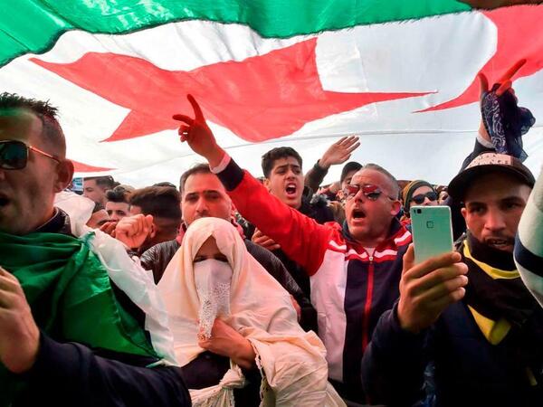 Protesters hold placards during a sit-in against the Algerian presidential bid for a fifth term in office (Twitter)