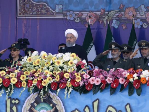 Iranian President Hassan Rouhani (C) and senior members of his armed forces watch a parade on the occasion of the country's annual Army Day on April 18, 2018, in Tehran. President Hassan Rouhani said during the parade that Iran "does not intend any aggression" against its neighbours but will continue to produce all the weapons it needs for its defence. ATTA KENARE / AFP