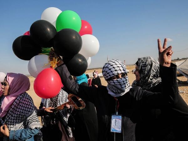 Colourful Balloons add spice! This is another side of resistance. Palestinian ladies have taken time off  in the hoisted tents made on the border with Israel in southern Gaza to protests her policies regarding Palestinian refugees, long dislocated from their homeland when Israel was created in 1948. Photo taken east of Rafah in the southern Gaza Strip on April 10, 2018. SAID KHATIB / AFP