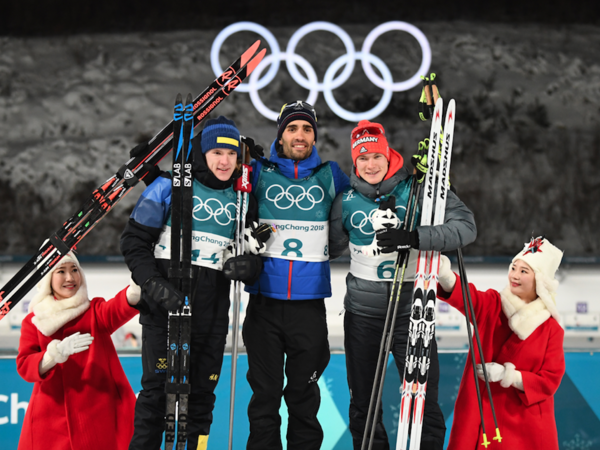 (L-R) Sweden's second place winner Sebastian Samuelsson, France's winner Martin Fourcade and Germany's third place Benedikt Doll pose on the podium during the victory ceremony after the men's 12,5km pursuit biathlon event during the Pyeongchang 2018 Winter Olympic Games in Pyeongchang on February 12, 2018. 
(FRANCK FIFE / AFP)