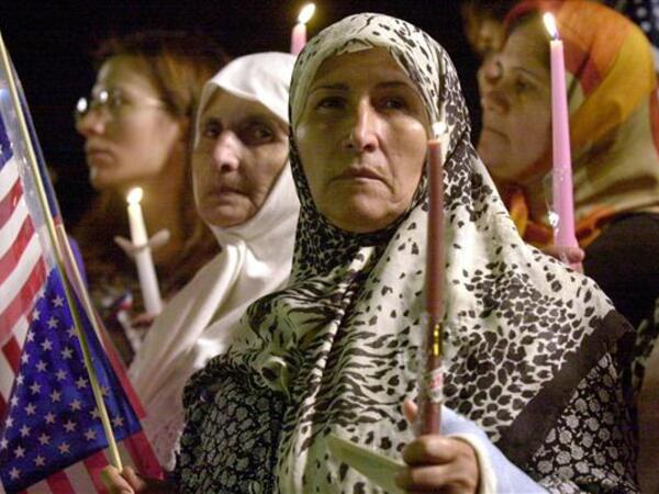 Members of the metro Detroit Arab community participate in a Peace and Unity Candlelight Vigil at Greenfield Village in Dearborn, Michigan, Sept. 19, 2001 in support for the victims of the September 11 attacks in New York and Washington. (AFP/Jeff Kowalskys)