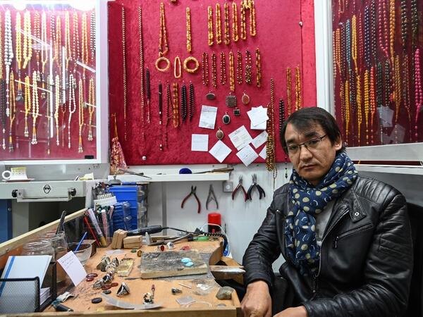 Hadi Ekhlas, engraver, poses for a picture at his workshop in the Grand Bazaar, in Istanbul.  OZAN KOSE / AFP