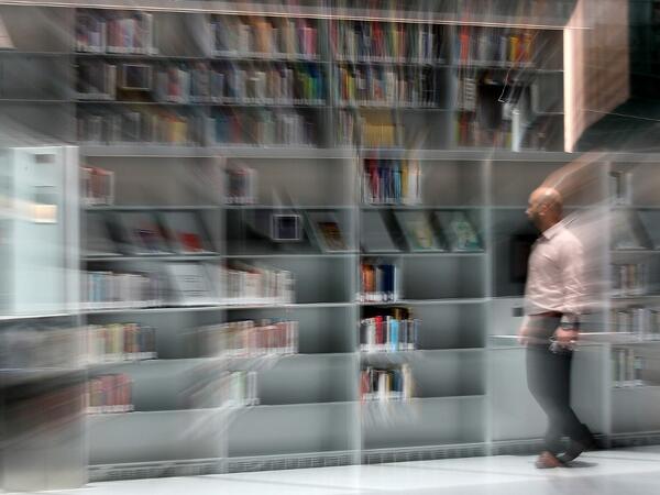 A man browses for books at the Qatar National Library in the capital Doha.  KARIM JAAFAR / AFP