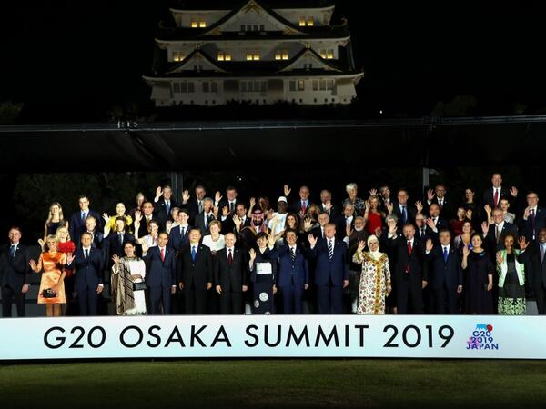 Leaders and their spouses pose for a group photo before a cultural event at the Osaka Geihinkan in Osaka Castle Park during the G20 Summit in Osaka on June 28, 2019.  Dominique JACOVIDES / POOL / AFP