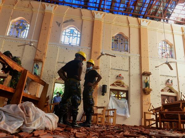 Security personnel inspect the interior of St Sebastian's Church in Negombo on April 22, 2019, a day after the church was hit in a series of bomb blasts targeting churches and luxury hotels in Sri Lanka. AFP