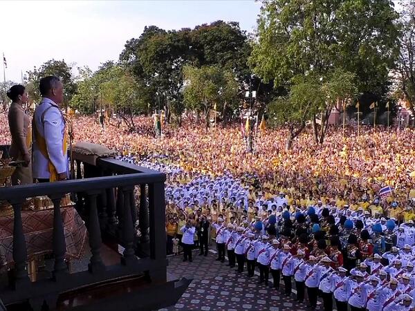 This frame grab from Thai TV Pool video taken on May 6, 2019 shows Thailand's King Maha Vajiralongkorn and Queen Suthida appearing on the balcony of Suddhaisavarya Prasad Hall of the Grand Palace as they grant a public audience on the final day of his royal coronation in Bangkok.  THAI TV POOL / AFP