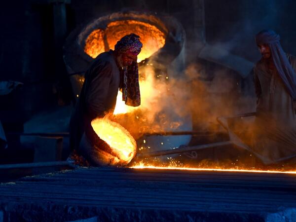 Pakistani labourers work at an iron factory in Lahore on April 30, 2019, on the eve of the International Labour Day celebrated on May 1.  ARIF ALI / AFP