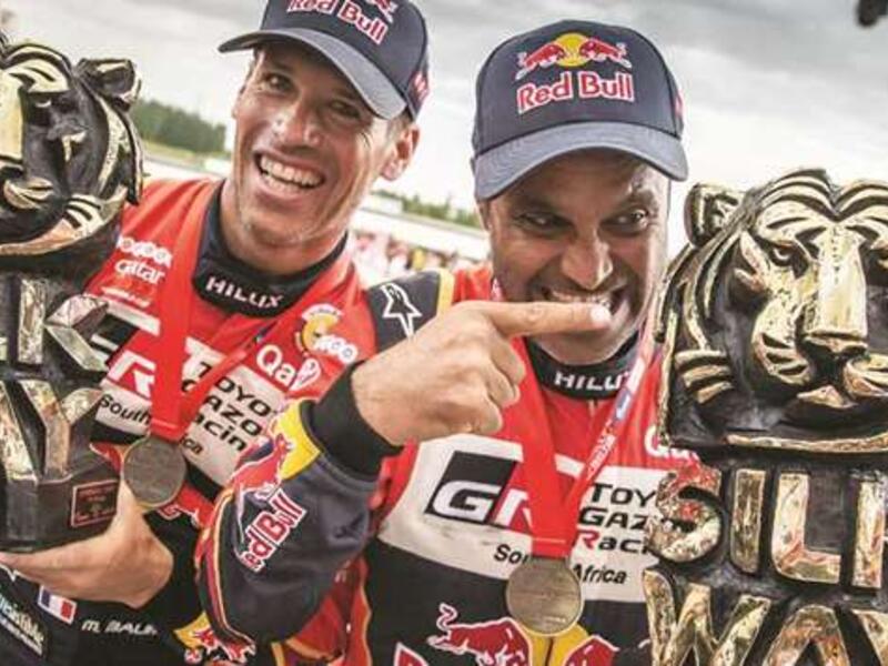 Qatar’s ace rally driver Nasser al-Attiyah (right) and his co-driver Mathieu Baumel of France celebrate after winning the Silk Way Rally in Dunhuang, China, on July 16, 2019 (Photo: Gulf Times)