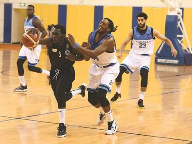 Al Sadd (in black) and Al Wakrah players vying for the ball during their Amir Cup basketball semi-final at the Al Gharafa Sports Club yesterday. (Photo: Shemeer Rasheed)