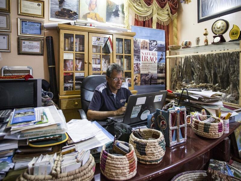 Jassim al-Assadi, director of Nature Iraq, an environmental activist group advocating for long-term ecotourism planning better protection for the Iraqi marshes, sits at his office in the southern district of Chibayish in Dhi Qar province. Hussein FALEH / AFP