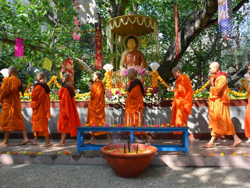 Buddhist monks offer prayers as they go around a sacred Bodhi tree during "Vesak" or Buddha Purnima to commemorate the 2,563rd birth anniversary of the Buddha, at the Maha Bodhi Society in Bangalore on May 18, 2019. MANJUNATH KIRAN / AFP