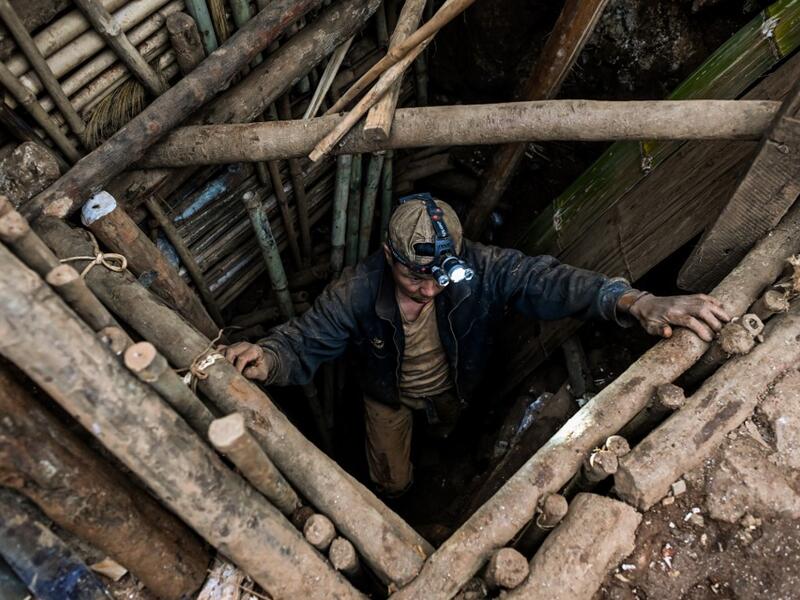 This photo taken on May 16, 2019 shows a miner entering a tunnel in a ruby mine in Mogok, north of Mandalay. Burrowing deep underground, thousands of informal miners risk their lives to find gleaming red gems as a law change spurs opportunity in Myanmar's "land of rubies". Ye Aung THU / AFP