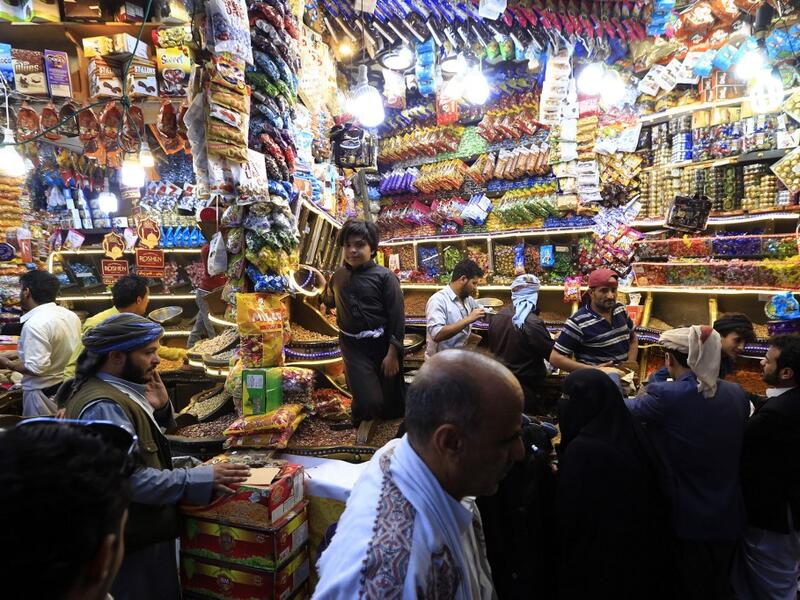 Yemenis shop for sweets and dried fruits in the capital Sanaa on May 28, 2019, during the holy Muslim month of Ramadan and ahead of Eid al-Fitr celebrations.  Mohammed HUWAIS / AFP