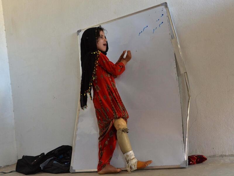 As 10 children from the same family were walking to school last year, they came across an unexploded mortar bomb - a common sight in Afghanistan, where war still rages between the Taliban and US-backed national forces. NOORULLAH SHIRZADA / AFP