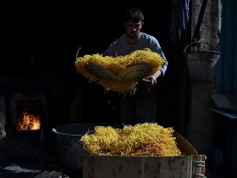 An Afghan worker prepares seemian, a local snack food made from flour and chilli, ahead of the Eid al-Fitr festival, which marks the end of Islamic holy month of Ramadan, at a traditional sweets factory in Kabul on June 2, 2019. WAKIL KOHSAR / AFP