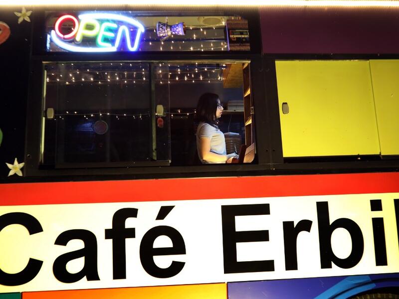 Kani Jalil, a 22-year-old Iraqi Kurdish woman who runs with her husband "The Bus Cafe Erbil" in Arbil, the capital of Iraq's Kurdish autonomous region, is pictured late on June 7, 2019, on the long weekend of the Eid al-Fitr holiday which marks the end of the Muslim holy month of Ramadan.  SAFIN HAMED / AFP