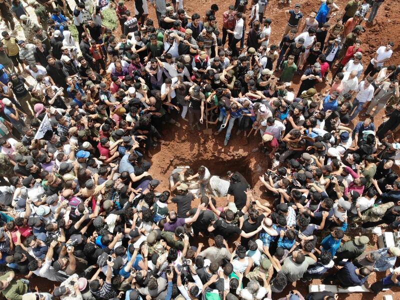 A picture taken with a drone on June 9, 2019 shows Syrians attending the burial of late rebel fighter Abdel-Basset al-Sarout in al-Dana in Syria's jihadist-controlled Idlib region, near the border with Turkey. OMAR HAJ KADOUR / AFP