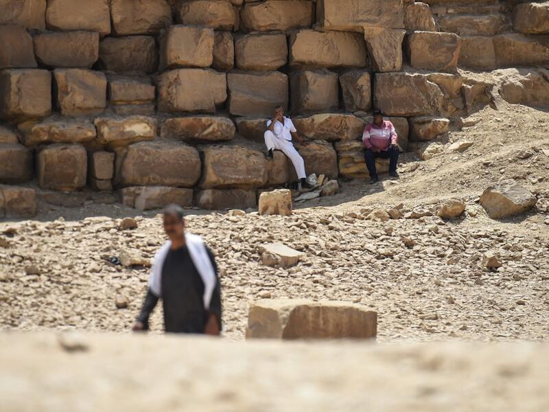 An Egyptian archaeological mission discovered a collection of stone, clay and wooden sarcophagi, of which some are still containing well preserved mummies, as well as a collection of wooden funerary masks and instruments used in cutting stones .  Mohamed el-Shahed / AFP