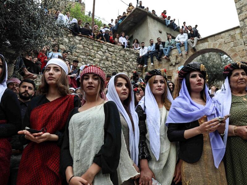 Iraqi Yazidi women light candles outside the Temple of Lalish, in a valley near the Kurdish city of Dohuk about 430 kilometres northwest of the capital Baghdad, on April 16, 2019, during a ceremony marking the Yazidi New Year. SAF