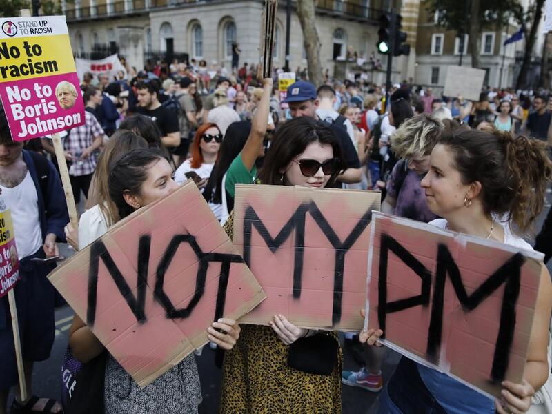 Demonstrators carry placards as they protest against Britain's newly appointed prime minister Boris Johnson outside Downing Street in London on July 24, 2019. Boris Johnson took charge as Britain's prime minister on Wednesday, on a mission to deliver Brexit by October 31 with or without a deal. Tolga AKMEN / AFP / POOL