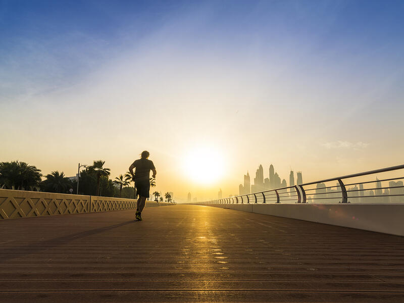 Man running with Dubai Skyline in background