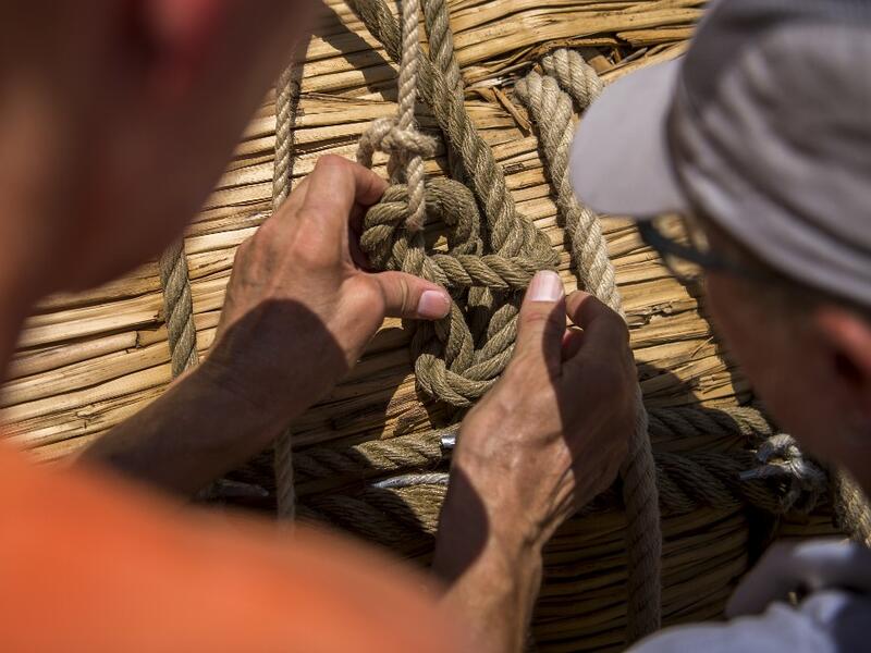 Members of the crew assemble the 14-meter long sailing reed boat Abora IV in the town of Beloslav, Bulgaria, on July 25, 2019. A team of two dozen researchers and volunteers from eight countries are preparing to set out in mid-August on a 1,300 kilometres (700 nautical mailes or 800 miles) journey to test the hypothesis that prehistoric trade routes traversed the high seas. NIKOLAY DOYCHINOV / AFP