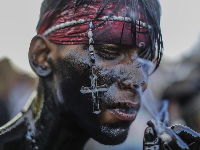 A catholic faithful smeared in burnt oil, takes part in the opening of the ten-day celebration of the Santo Domingo de Guzman festival in Managua, on August 1, 2019.  INTI OCON / AFP